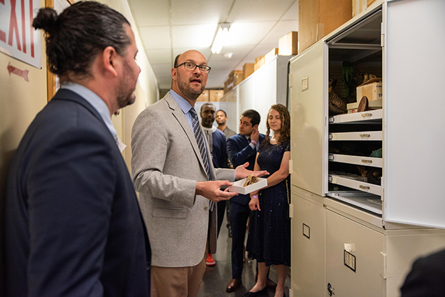 Academy Ornithologists showing a skull during an evening event.
