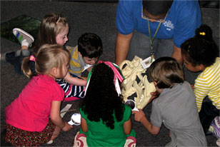 tiny tot exploreres checking out a lion skull