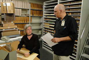 Academy archivist and a library volunteer discuss the work agenda